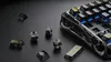 Close-up view of mechanical keyboard switches and keycaps scattered around a portion of a keyboard. Produktbild-Vorschau