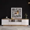 A TV stand with drawers and shelves in a room with a black textured wall. Voir les images du produit