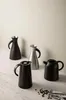 Four thermoses are arranged on a marble surface in front of a light gray wall. Produktbild-Vorschau