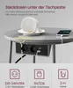 A round side table with a power strip and USB ports mounted underneath. A spilled cup of coffee is shown on the table, demonstrating the safety feature of the under-table power strip. Produktbild-Vorschau