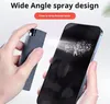 A hand is spraying a screen cleaner onto a smartphone screen. Produktbild-Vorschau