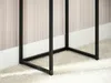 Close-up view of the black metal legs of a console table resting on a white rug. Náhled obrázku produktu