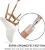 A white chair is shown with its legs up, and a close-up inset shows a person using pliers to put a clear silicone chair leg cap with a felt bottom onto a wooden chair leg. Náhled obrázku produktu
