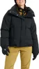 A woman wearing a black puffer jacket and tan pants, posing for a product shot. Náhľad obrázku produktu