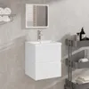A bathroom vanity with a mirror and sink, mounted on a tiled wall. Náhľad obrázku produktu