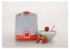 A yogurt maker with strawberries and a bowl of yogurt. Produktbild-Vorschau