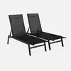 Two black lounge chairs are shown against a white background.