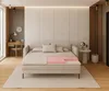 A bedroom or living space featuring a daybed or sofa bed with a mattress topper clearly displayed, showcasing its layers. The room has a modern, minimalist design with wooden accents and soft lighting. Produktbild-Vorschau