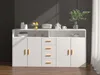 A white sideboard cabinet with yellow handles, featuring drawers and doors, set against a dark grey wall with natural light casting shadows. Voir les images du produit