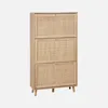 A tall, narrow shoe cabinet with three flip-down doors, each featuring a woven rattan panel. The cabinet is made of light-colored wood and stands on four tapered legs. Produktbild-Vorschau