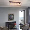 A living room scene with a fireplace, artwork, furniture, and a doorway leading to a balcony. Voir les images du produit