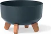 A dark gray planter with three brown legs, shown against a white background. Náhled obrázku produktu