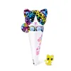 A rainbow-colored plush cat toy in a cone-shaped wrapper, with a small yellow cat figurine next to it. Podgląd zdjęcia produktu