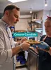 Two people in a kitchen preparing a pizza. Produktbild-Vorschau