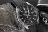 A close-up shot of a black Casio Edifice watch with a leather strap, resting on a dark, textured rock. Voir les images du produit