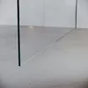 A close-up view of a glass shower partition on a light gray tiled floor, with a white wall in the background. Anteprima dell’immagine prodotto