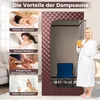 A woman in a bathrobe holds a drink next to a portable steam sauna. Náhľad obrázku produktu