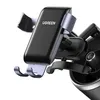 A close-up shot of a black and gray UGREEN gravity phone holder mounted on a car's air vent. Anteprima dell’immagine prodotto