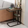 A small side table with books and decorative vases next to a sofa. Produktbild-Vorschau