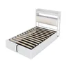 A white metal bed frame with a slatted base and a headboard with storage shelves. Produktbild-Vorschau