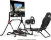 A racing simulator cockpit setup with a monitor, steering wheel, pedals, and seat, shown against a white background. Produktbild-Vorschau