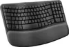 A black ergonomic keyboard with a padded wrist rest is shown from a slightly elevated front-facing angle against a white background. Anteprima dell’immagine prodotto