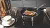 A steak is being cooked in a pan on a stovetop, with a cup and saucer nearby. Produktbild-Vorschau
