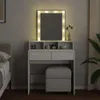 A white vanity table with a lighted mirror and a stool in a bedroom setting. Produktbild-Vorschau