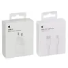 Two white product boxes are shown side-by-side against a white background. The box on the left displays an image of a white power adapter and text indicating it is a USB-C 20W Power Adapter. The box on the right shows an image of a white USB-C to Lightning Produktbild-Vorschau