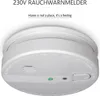 A white 230V smoke detector is shown from a slightly angled top-down view, mounted on a white ceiling. Produktbild-Vorschau