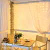 A table set for a meal with string lights in the background. Anteprima dell’immagine prodotto