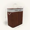 A laundry basket with two compartments, made of bamboo, with dimensions indicated. Produktbild-Vorschau