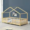 A wooden house-shaped bed frame with a mattress and bedding, set against a blue wall. Náhled obrázku produktu