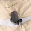 A close-up view of an air pump and accessories nestled within a beige fabric cover. Produktbild-Vorschau