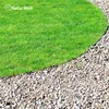A close-up view of a lawn edge with a curved border of gravel next to green grass. Produktbild-Vorschau