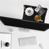 A desk setup with a monitor, keyboard, mouse, and a shelf on top of the monitor holding a calculator, a cup of tea, and a decorative item. Produktbild-Vorschau