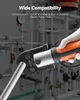 A gloved hand holds an orange and silver press tool, with a metal pipe inserted into its jaws. The background shows a network of pipes and gauges, suggesting a plumbing or industrial setting. Podgląd zdjęcia produktu