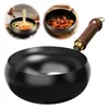 A collage showing a wok being used to cook noodles and stir-fried meat, with a close-up of the wok itself. Produktbild-Vorschau