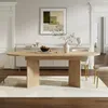A dining room scene with an oval wooden table as the centerpiece, set against a backdrop of elegant wall paneling and a framed abstract artwork. Náhľad obrázku produktu