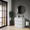 A modern living room scene featuring a white dresser, a round mirror, and decorative plants. Produktbild-Vorschau