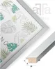 A close-up view of a picture frame with a botanical print, and a separate image showing a cross-section of the frame's profile with dimensions. Produktbild-Vorschau