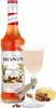 A bottle of Monin Winter Spice syrup and a glass of a creamy drink, with spices like cinnamon and ginger arranged around them. Podgląd zdjęcia produktu