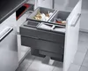 A pull-out kitchen waste sorting system with multiple bins, shown partially extended from a cabinet. Voir les images du produit