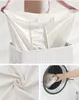 A collage showing a person holding a laundry bag, a close-up of the fabric, and laundry being put into a washing machine. Produktbild-Vorschau