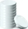 A stack of white jar lids with one lid placed in front of the stack. Podgląd zdjęcia produktu