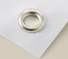 A close-up of a metal grommet on a white textured material, likely a banner or poster. Produktbild-Vorschau