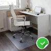 A transparent floor mat is placed under a white office chair in front of a desk. Produktbild-Vorschau