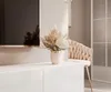 A modern living room setting with a TV stand, a vase of dried flowers, and a chair. Produktbild-Vorschau