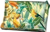 A decorative cushion with a tropical pattern featuring parrots, bananas, and pineapples on a light yellow background. Náhled obrázku produktu