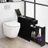A black slim storage cabinet with drawers and shelves next to a white wall-mounted toilet in a bathroom. Náhľad obrázku produktu